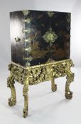 A 17th century chinoiserie lacquered cabinet on stand, with two doors decorated with traditional