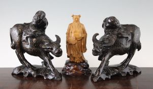 A Chinese boxwood figure of Zhongli Quan and a pair of wood and metal wire buffalo groups, 20th