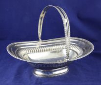 A George III silver cake basket, of rounded rectangular form, with engraved armorial, gadrooned