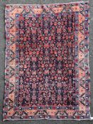 An Afghan rug, with extensive field of geometric and foliate motifs on a deep blue ground, with