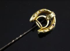 A gold horseshoe and stirrup stick pin, 3in.