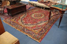 A Tabriz carpet, with central oval foliate medallion within a polychrome field of scrolling