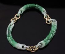 A high carat gold chain link and carved jadeite bracelet, carved with flowers and fruit.