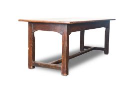 A FRENCH STAINED PINE KITCHEN TABLE, LATE 19TH CENTURY, the long planked top and cleated ends