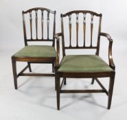 A set of six Sheraton style mahogany dining chairs, two with arms and four singles, with green