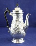 A Victorian 18th century style silver coffee pot, of baluster form, with ebonised handle and