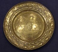 A 16th / 17th century Flemish embossed brass alms dish, probably Nuremberg, with a broad rim and