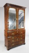 A large 18th century burr walnut secretaire cabinet, fitted with a pair of shaped mirror doors