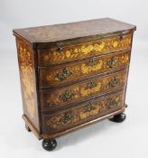 A Dutch marquetry inlaid batchelor`s chest, the folding top revealing baize lined interior over