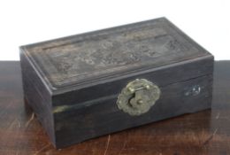 A Chinese rosewood box, the hinged cover carved in high relief with boys playing in a courtyard amid