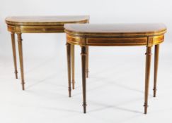 A pair of George III rosewood and satinwood banded D shaped card tables, with slender turned and