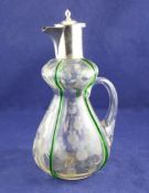An Edwardian Art Nouveau silver mounted cut glass claret jug, of double gourd shape, with hinged
