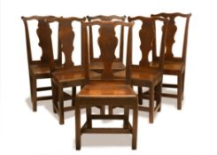 A SET OF SIX GEORGE III OAK DINING CHAIRS, MID 18TH CENTURY, the shaped eared cresting rails above