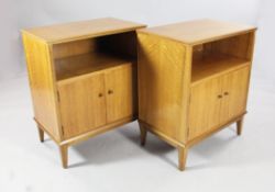 A pair of mid 20th century walnut bedside cupboards, with open space and cupboard doors below, by AC