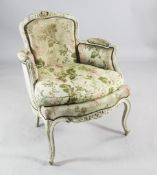 A Louis XV style tub shaped armchair, with upholstered back and sides and deep serpentine seat, on