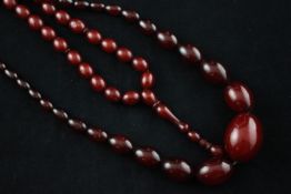 Two red amber bead necklaces.