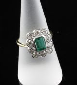 A gold, emerald and diamond set dress ring, ring size O. A gold, emerald and diamond set dress ring,