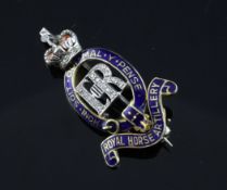 A gold, diamond and two colour enamel Royal Horse Artillery brooch, 1.5in. A gold, diamond and two