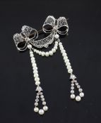 A 1920`s gold, silver, diamond and seed pearl set twin bow brooch, 2.25in. A 1920`s gold, silver,