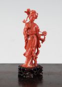 A Chinese coral figure of a female immortal holding flowers A Chinese coral figure of a female