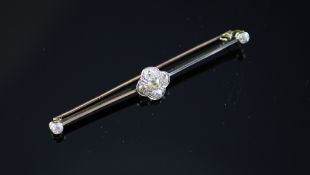 A gold and diamond set bar brooch, 2.75in. A gold and diamond set bar brooch, with flowerhead centre