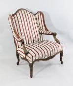 A 19th century French carved beech wing back armchair, A 19th century French carved beech wing