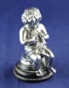 A Victorian silver figure of a putto playing the pipes, 4in. A Victorian silver figure of a putto