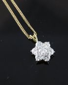 An 18ct gold and seven stone diamond flowerhead pendant, An 18ct gold and seven stone diamond
