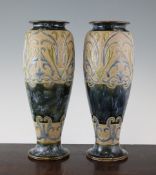 A pair of Doulton Lambeth stoneware slender baluster vases A pair of Doulton Lambeth stoneware