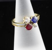 A gold, ruby, sapphire and diamond set clover design dress ring, size I. A gold, ruby, sapphire