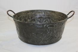 A 17th century copper twin handled pan, 19.5in. A 17th century copper twin handled pan, embossed and