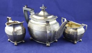 A late Victorian silver three piece tea set, gross 31.5 oz. A late Victorian silver three piece