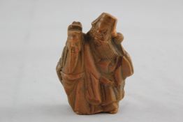 A rare Chinese realgar group of two standing sages, 17th century, 3.75in. (9.6cm), one head re-stuck