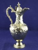 An ornate Victorian silver gilt pedestal hot water jug, gross 30 oz. An ornate Victorian silver gilt