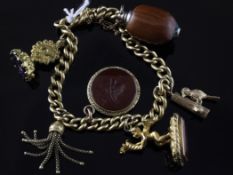 An 18ct gold curb link charm bracelet hung with six charms including fob seal and intaglio, An