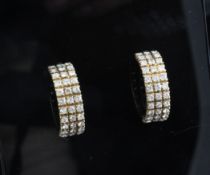 A pair of 18ct gold and pave diamond set half hoop earrings, 0.75in. A pair of 18ct gold and pave