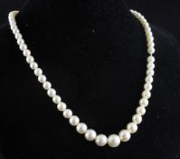 A single strand graduated cultured pearl choker necklace with marquise diamond set white gold clasp,