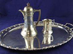 An Edwardian silver oval two-handled tea tray, pot and jug, gross 102.5 oz. An Edwardian silver oval