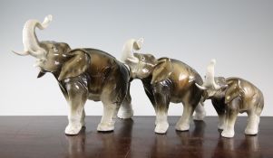 A graduated set of three Royal Dux pottery elephants, 9in. - 13.25in. A graduated set of three Royal