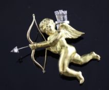 A French 18ct two colour gold and diamond set Cupid brooch by Mellerio, Paris, 1.75in. A French 18ct