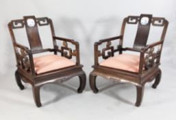 An unusual pair of early 20th century Chinese rosewood armchairs, An unusual pair of early 20th