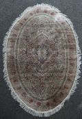 An Isphahan style oval silk rug, 8ft 2in by 5 ft. An Isphahan style oval silk rug, with central