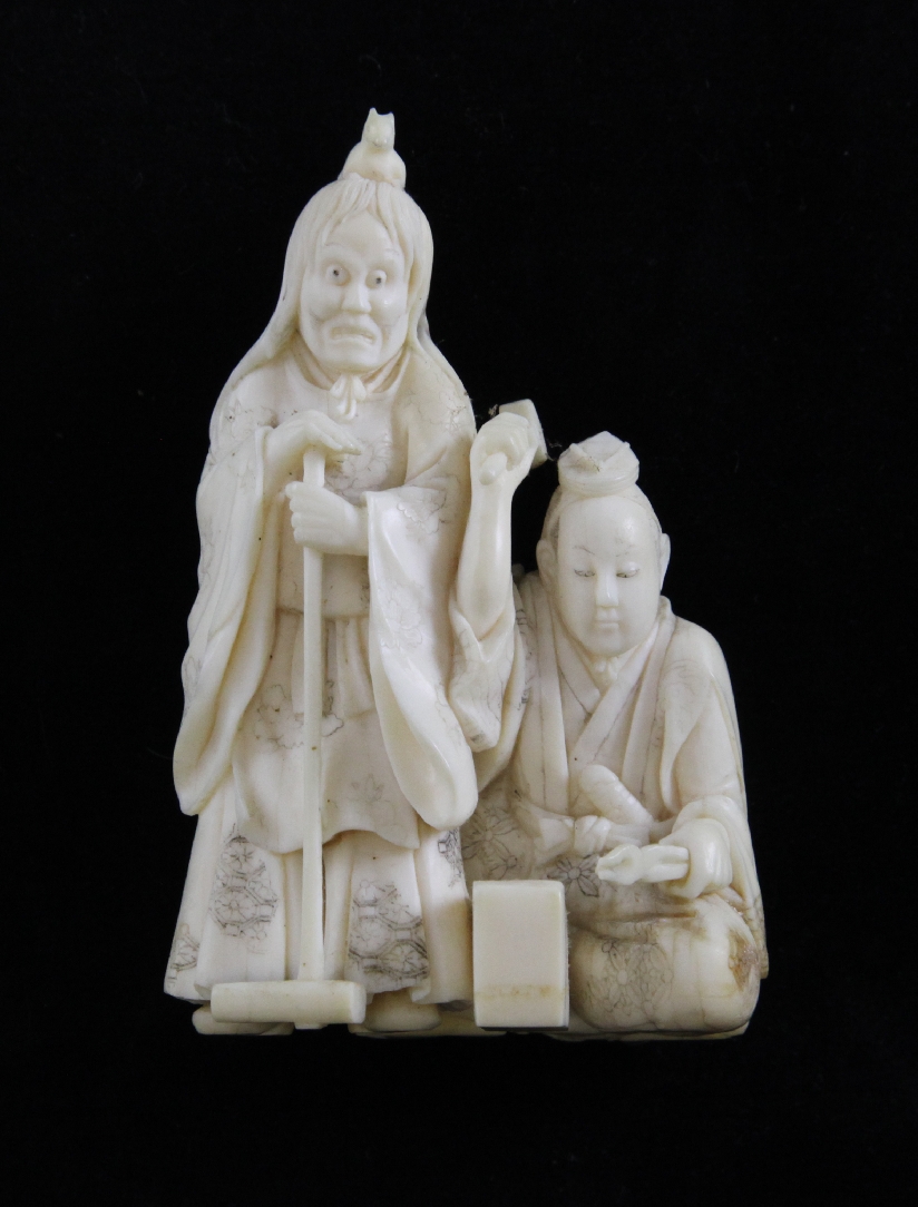 A Japanese ivory okimono carved as a blacksmith and assistant, 4in. A Japanese ivory okimono