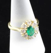 An 18ct gold, emerald and diamond cluster ring, size Q. An 18ct gold, emerald and diamond cluster