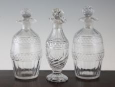 A pair of decanters and stoppers and cruet bottle A pair of Regency barrel shaped cut glass