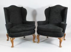 A pair of George II design wingback armchairs A pair of George II design carved and stained beech