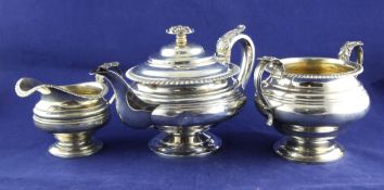 A matched George IV and later silver pedestal three piece tea set, gross 42.oz. A matched George