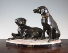 An Art Deco patinated metal figure group of two dogs, 17in. An Art Deco patinated metal figure group