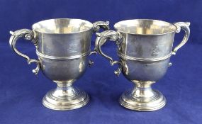 A pair of George III Irish silver two-handled pedestal cups, 26.5 oz. A pair of George III Irish