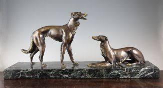 A large Art Deco patinated bronze figure group, modelled as two dogs, 30in. A large Art Deco